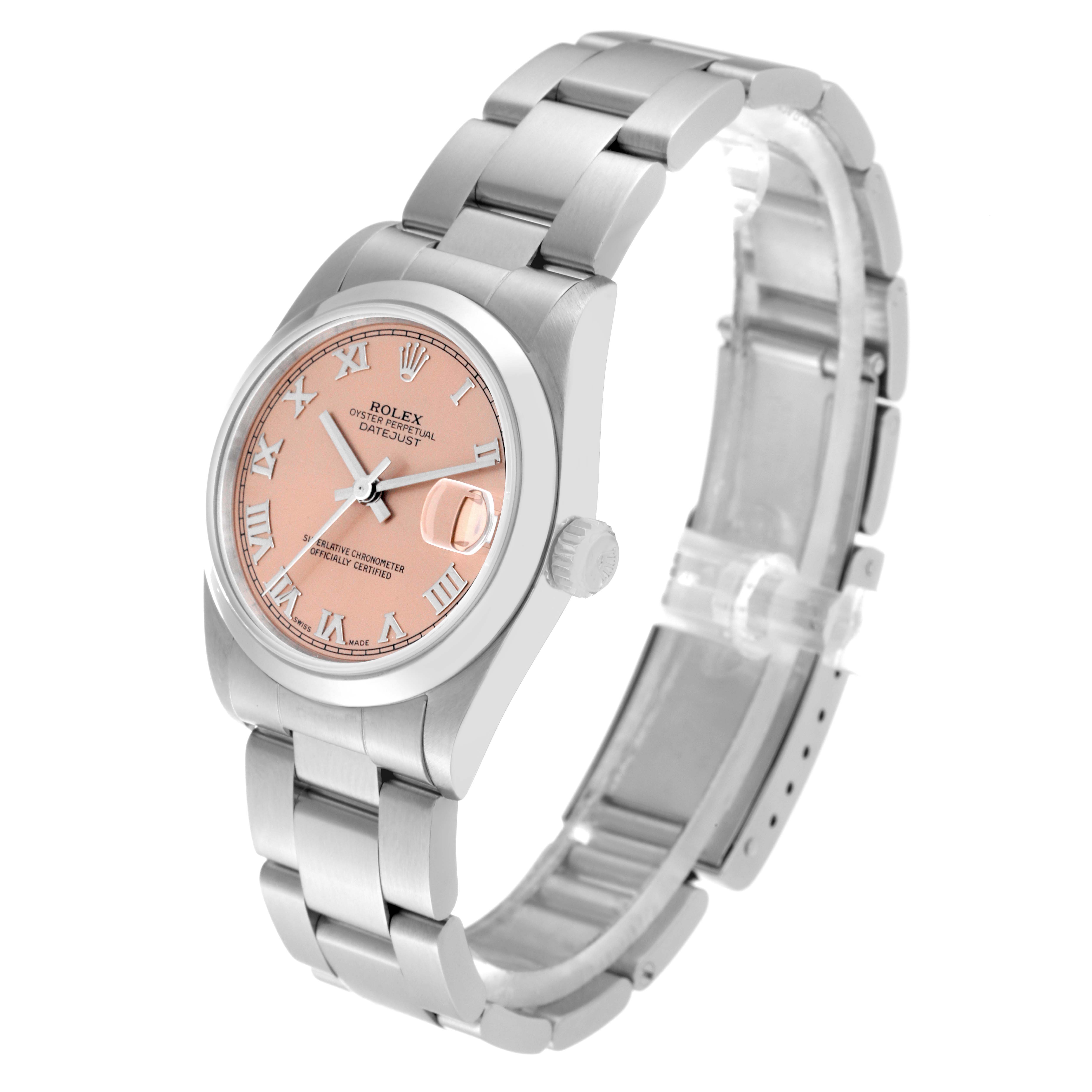 This image shows a Rolex Mid-Size 78240 Women's Stainless Steel Pink Dial 78240 Women's Stainless Steel Pink Dial watch taken at an angled view, highlighting its peach dial, Roman numerals, and stainless steel bracelet.