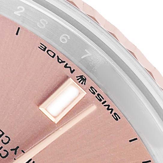 The image shows a close-up of the Rolex Mid-Size 278271 Women's Steel and Gold (two tone) Pink Dial model displaying part of the dial, hour markers, and bezel with numbers.
