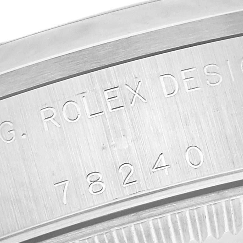 The image shows a close-up of the serial number and engravings on the side of a Mid-Size Rolex watch case.
