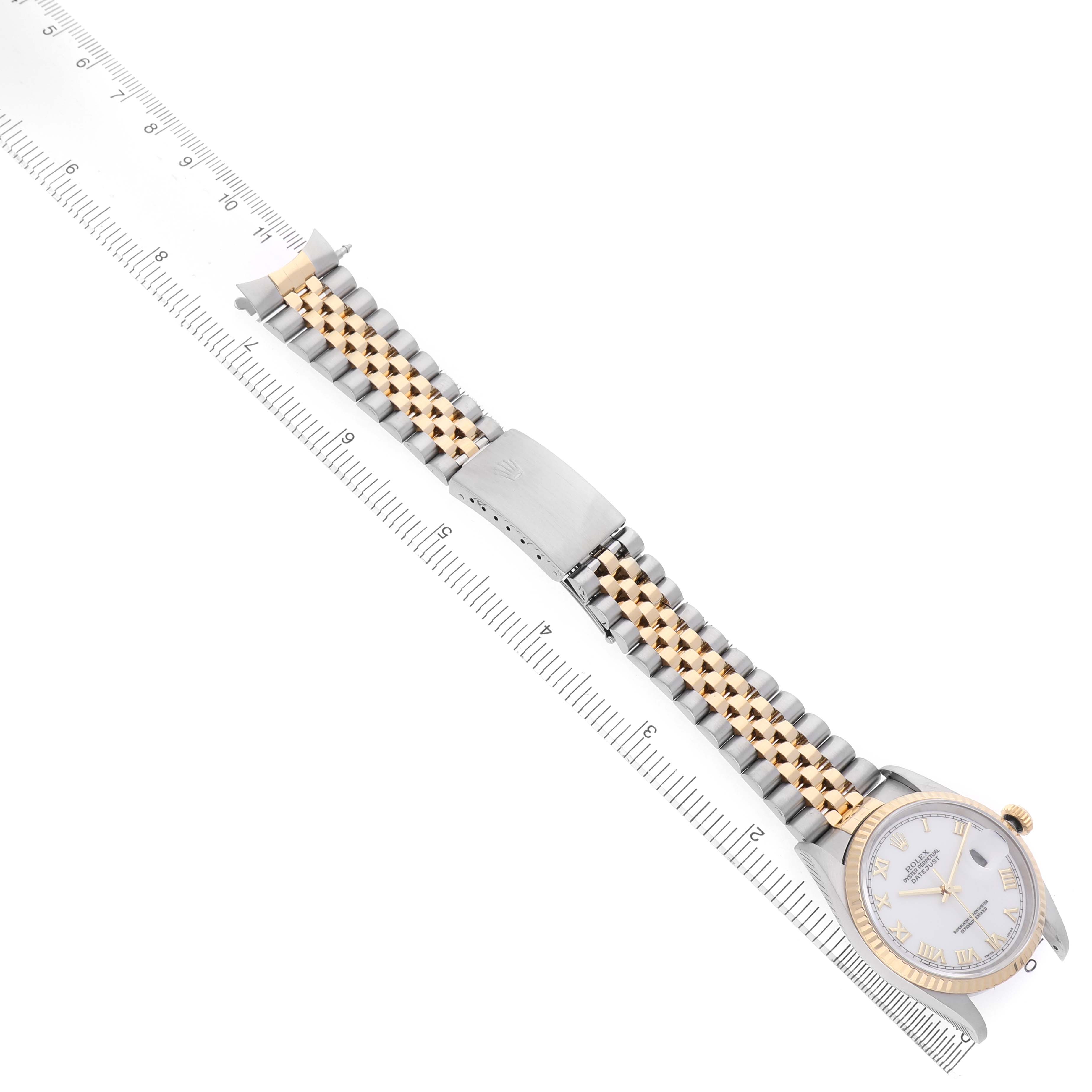 The Rolex Datejust 16233 Men's Stainless Steel White Dial watch is shown from a top angle, highlighting the face, bracelet, clasp, and bezel with a ruler for scale.
