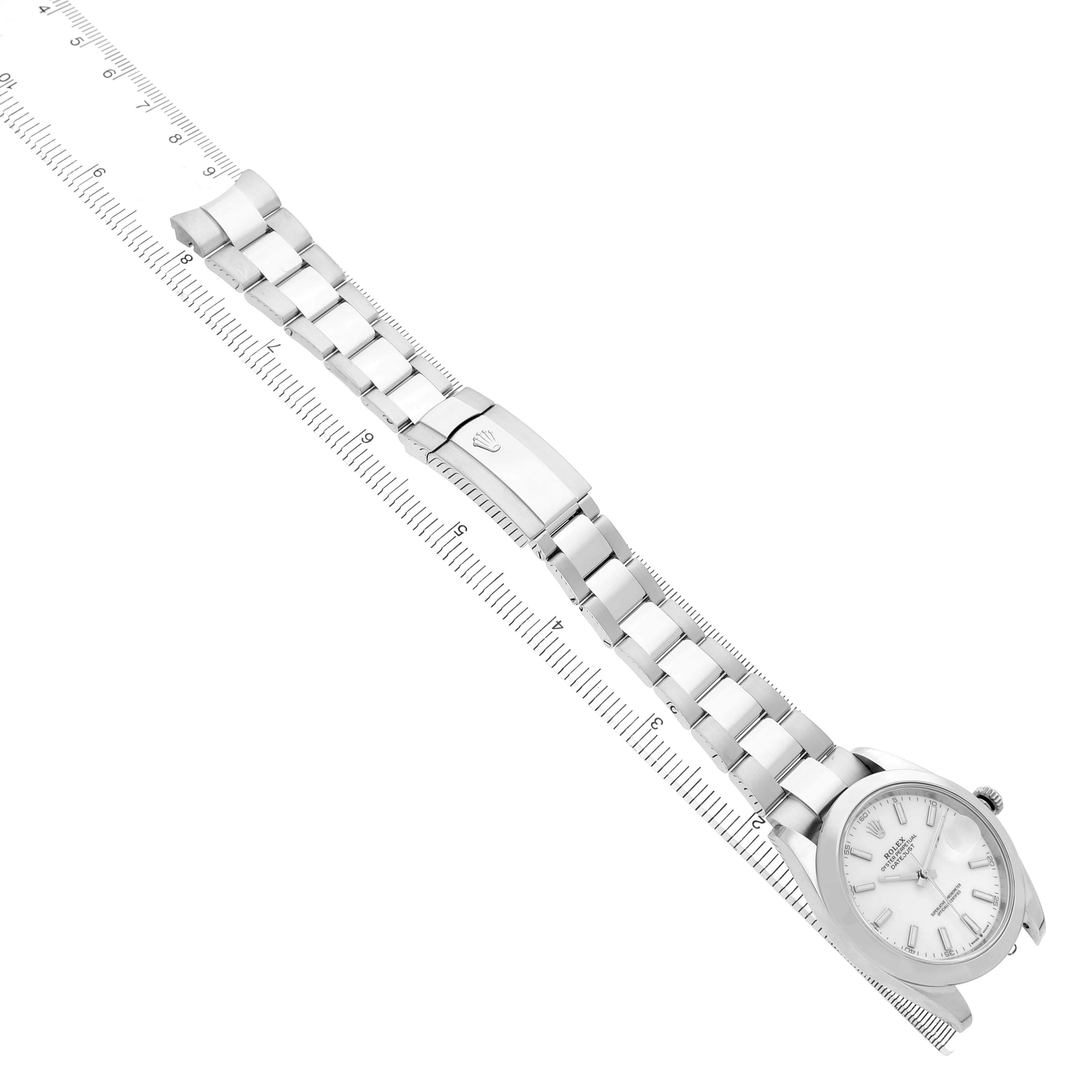 The Rolex Datejust 41 126300 Men's Stainless Steel White Dial watch is shown from a diagonal angle, displaying its bracelet, clasp, and face alongside a ruler for scale.