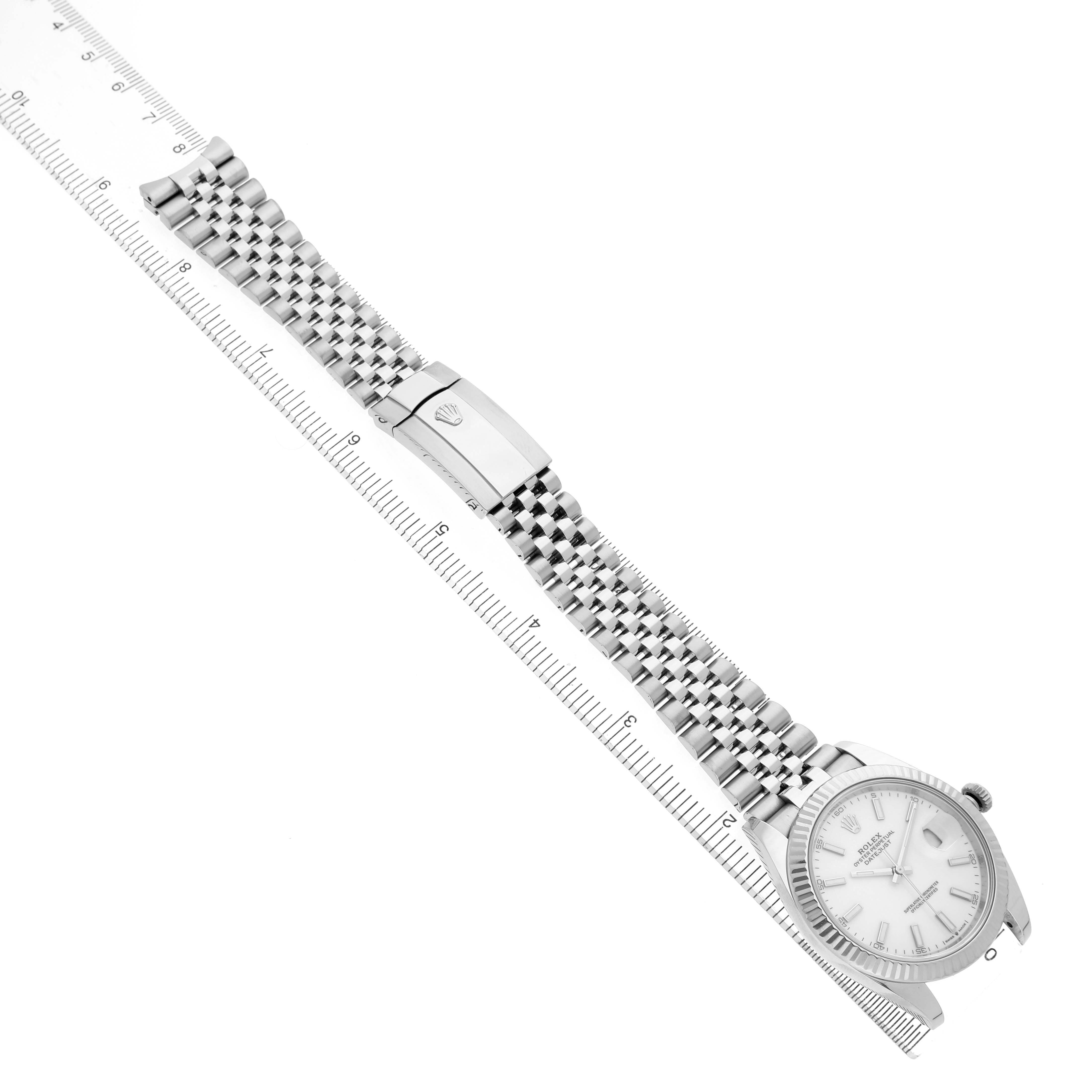 The Rolex Datejust 41 126334 Men's Stainless Steel White Dial is shown from the top view, featuring the bracelet and clasp alongside a ruler for scale.