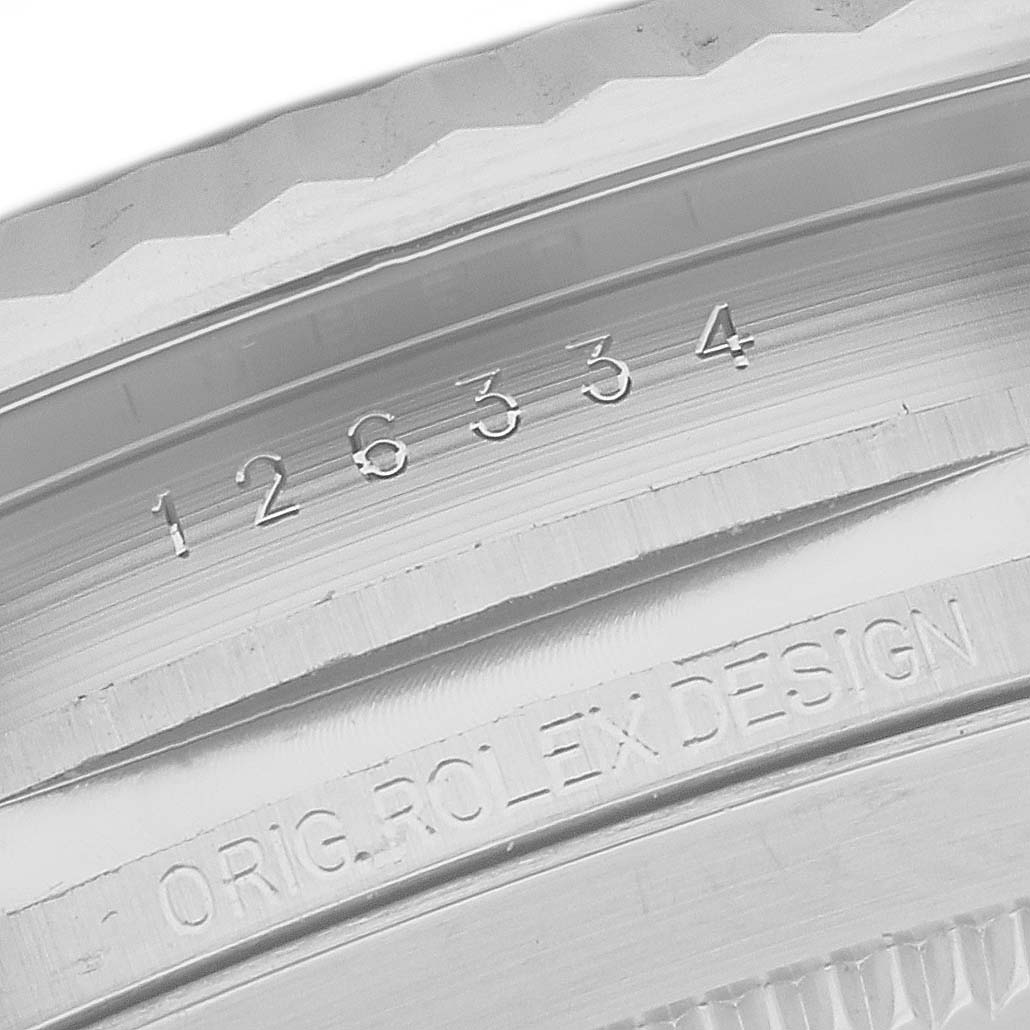 This image shows a close-up of the inner bezel of the Rolex 126334 Men
s Stainless Steel Grey Dial 126334 Men
s Stainless Steel Grey Dial Datejust 41 Steel White Gold Wimbledon Dial Mens Watch, model 126334, displaying engraved details.