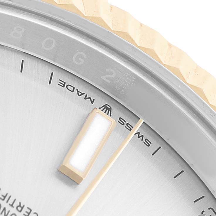 The image shows a close-up of the Rolex Datejust 41 126333 Men's Steel and Gold (two tone) Silver Dial's dial and bezel, highlighting the "SWISS MADE" text, an index marker, and fluted bezel.