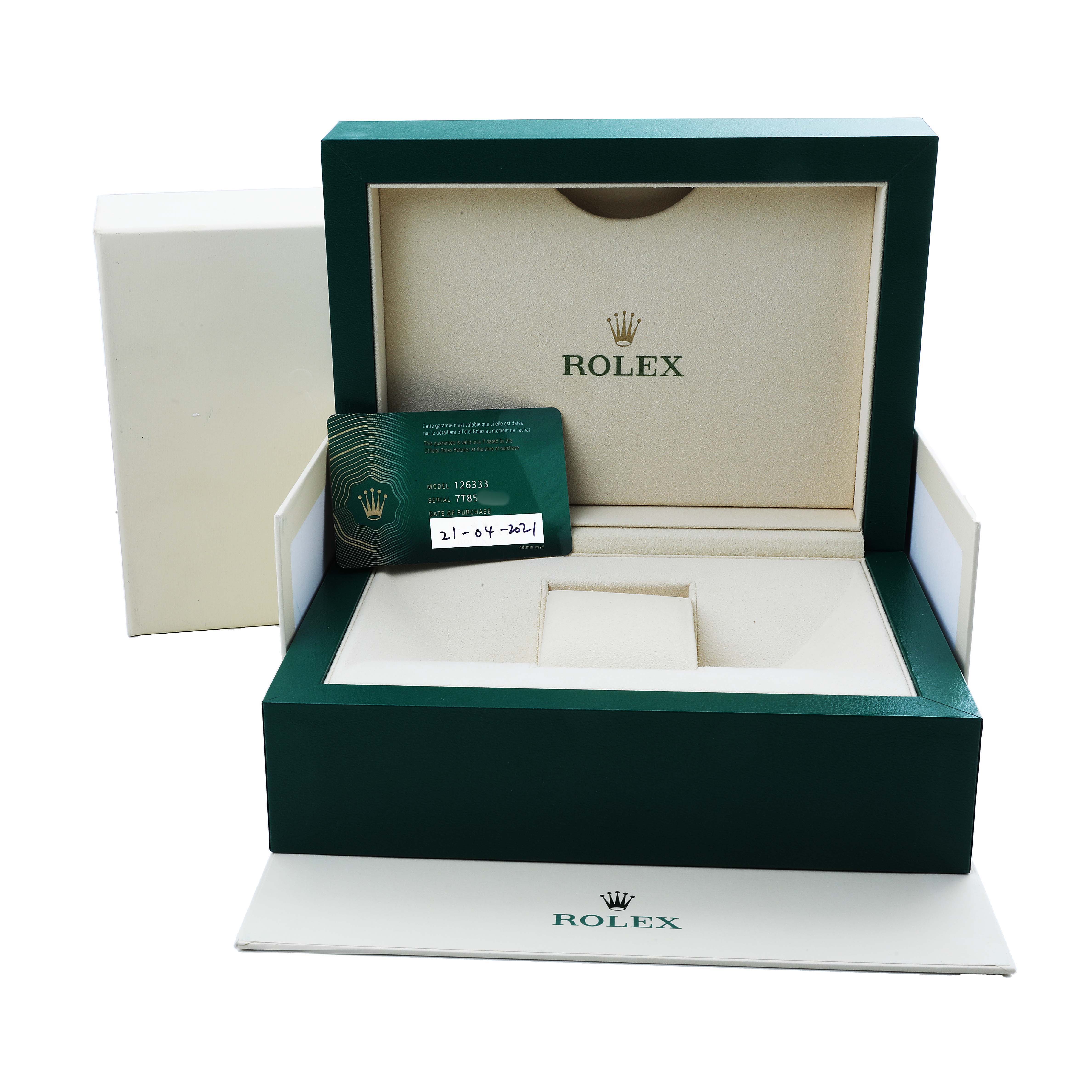 The image shows an open presentation box for the Rolex Datejust 41 126333 Men's Steel and Gold (two tone) Silver Dial, with accompanying papers and a green card.