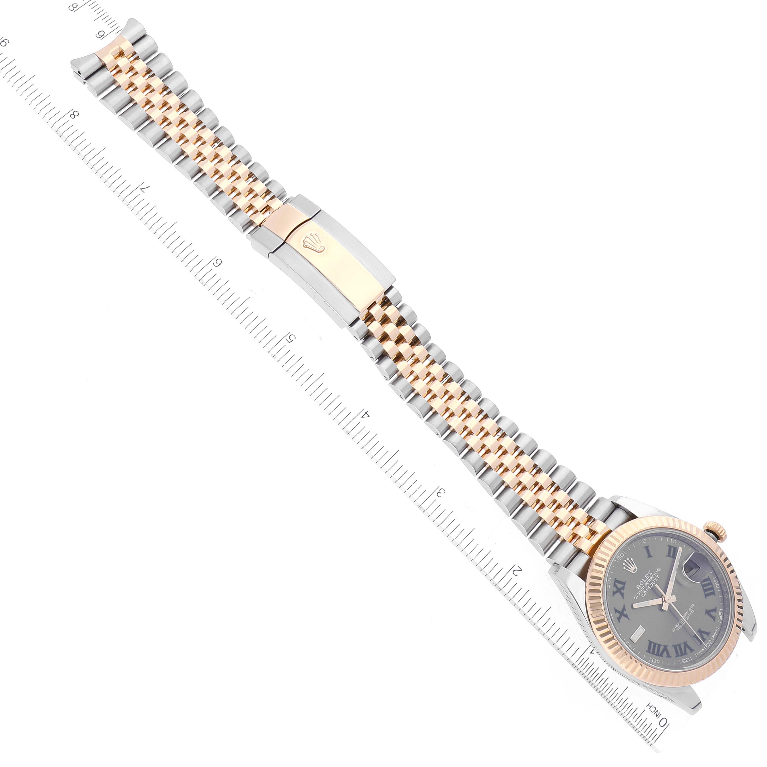 This image shows the overhead view of the Rolex Datejust 41 126333 Men's Steel and Gold (two tone) Grey Dial 126333 Men's Steel and Gold (two tone) Grey Dial, displaying the watch dial, bezel, bracelet, clasp, and a measuring ruler.