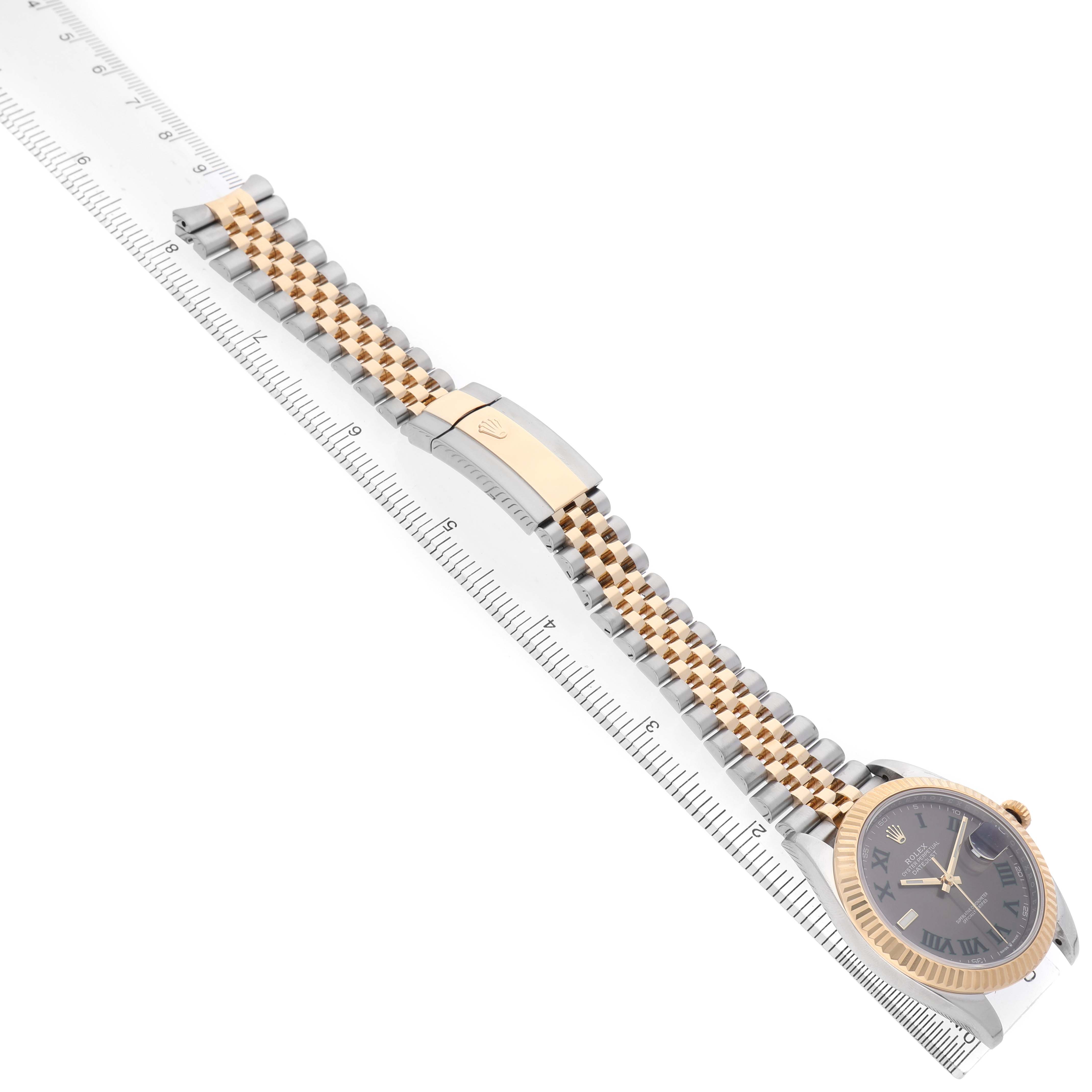 The Rolex Datejust 41 126333 Men's Steel and Gold (two tone) Grey Dial is shown diagonally, highlighting its jubilee bracelet and fluted bezel alongside a ruler for scale.