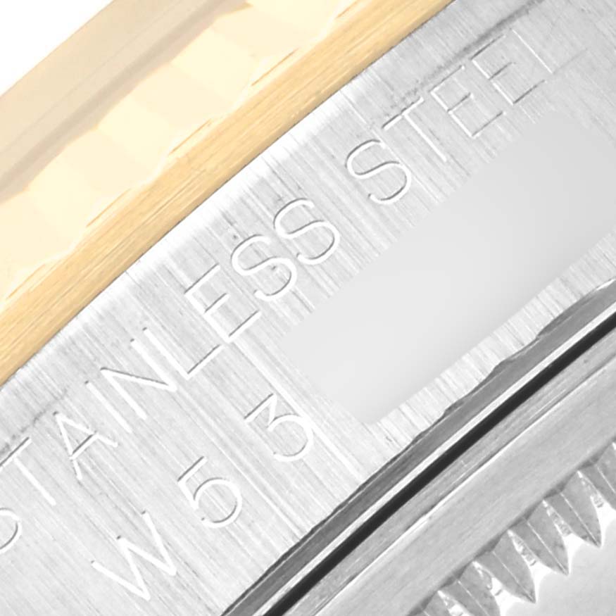 The image shows a close-up of the side engraving and fluted bezel of a Rolex Datejust 16233 Men's Steel and Gold (two tone) Blue Dial 16233 Men's Steel and Gold (two tone) Blue Dial, highlighting the "Stainless Steel" inscription.