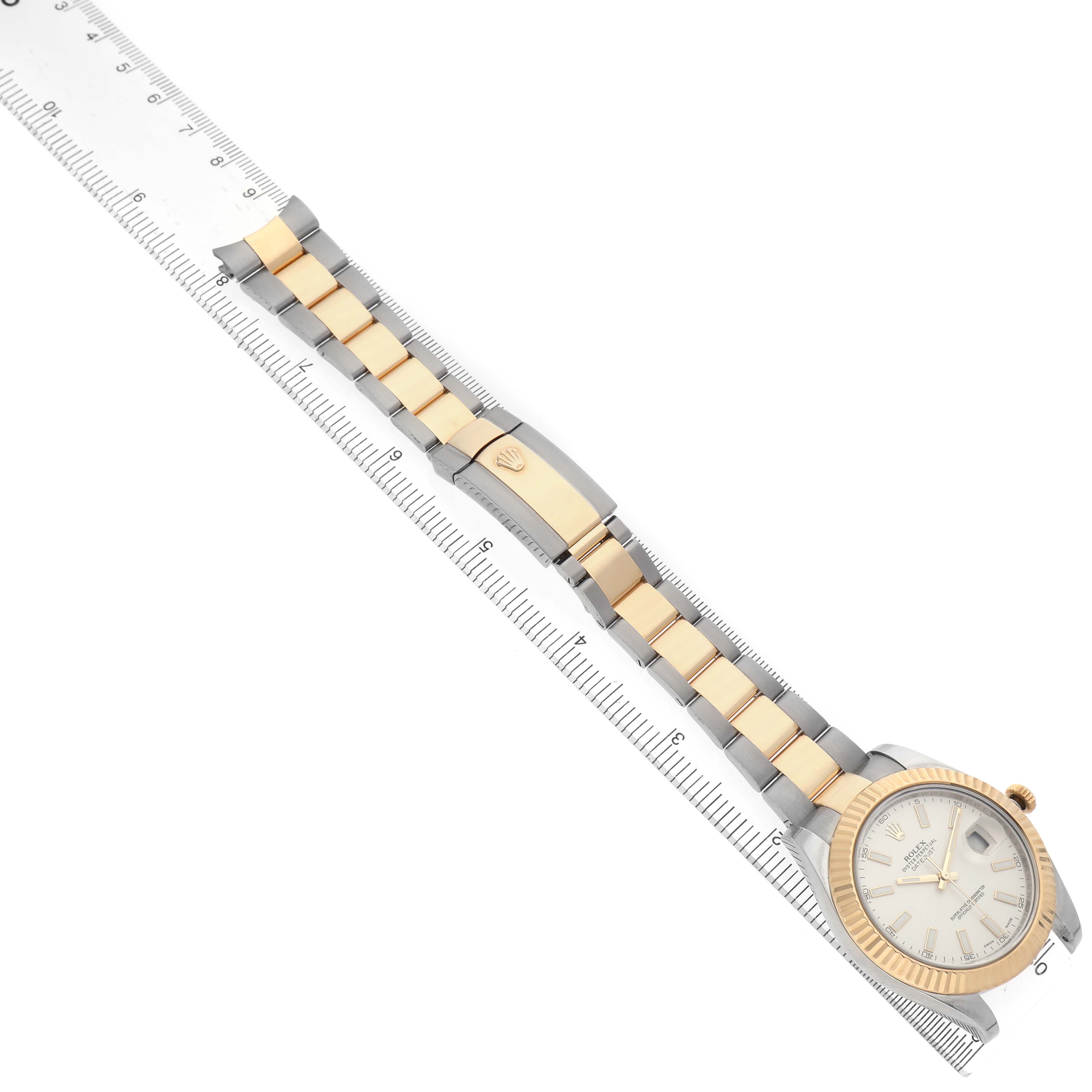 The Rolex Datejust 41 116333 Men's Steel and Gold (two tone) Silver Dial is shown from a top-down angle, displaying the full bracelet and watch face, accompanied by a ruler for scale.
