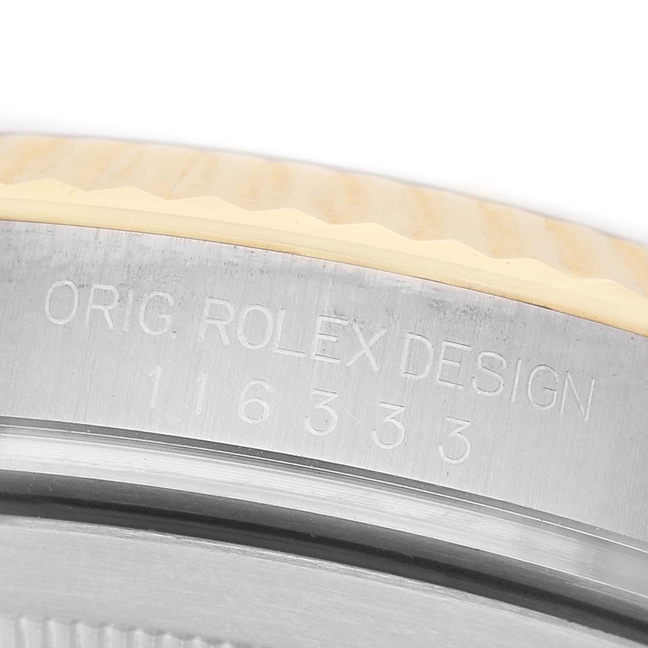 The image shows a close-up of the engraved side of a Rolex Datejust 41 116333 Men's Steel and Gold (two tone) Silver Dial model case, highlighting the design details.