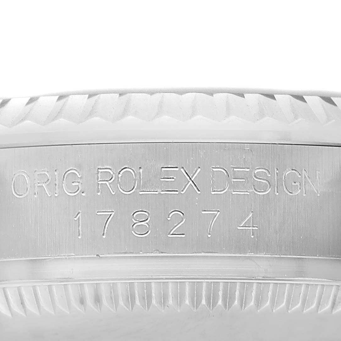 The image shows a side view of the Rolex Mid-Size 178274 Women's Stainless Steel Black Dial model 178274, focusing on the engraved bezel and case details.