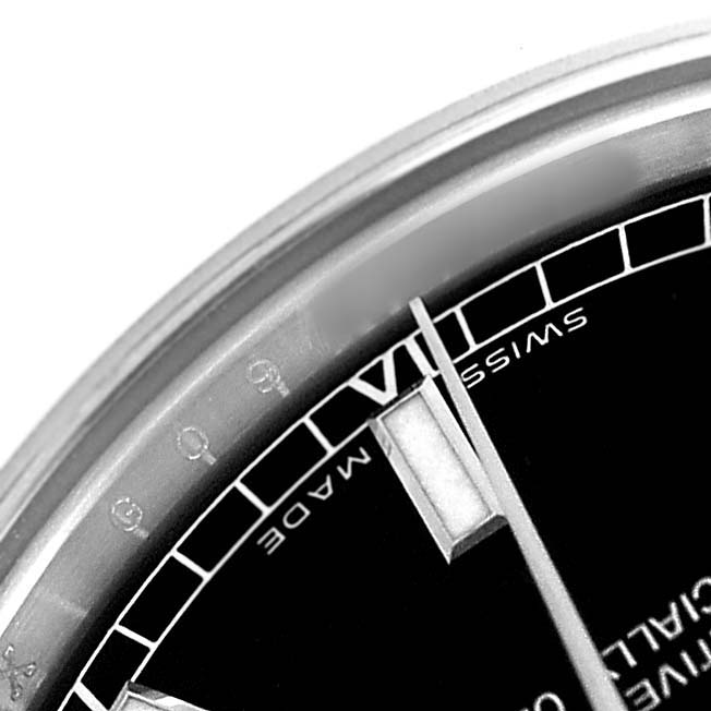 The image shows a close-up of the dial of a Mid-Size Rolex, highlighting the Roman numerals and minute markers.