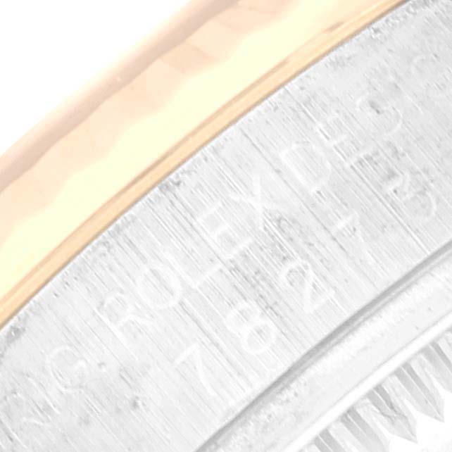 This image shows a close-up of the side of a Rolex Mid-Size 178273 Women
s Steel and Gold (two tone) Black Dial 178273 Women
s Steel and Gold (two tone) Black Dial watch, displaying part of the engraved serial number.