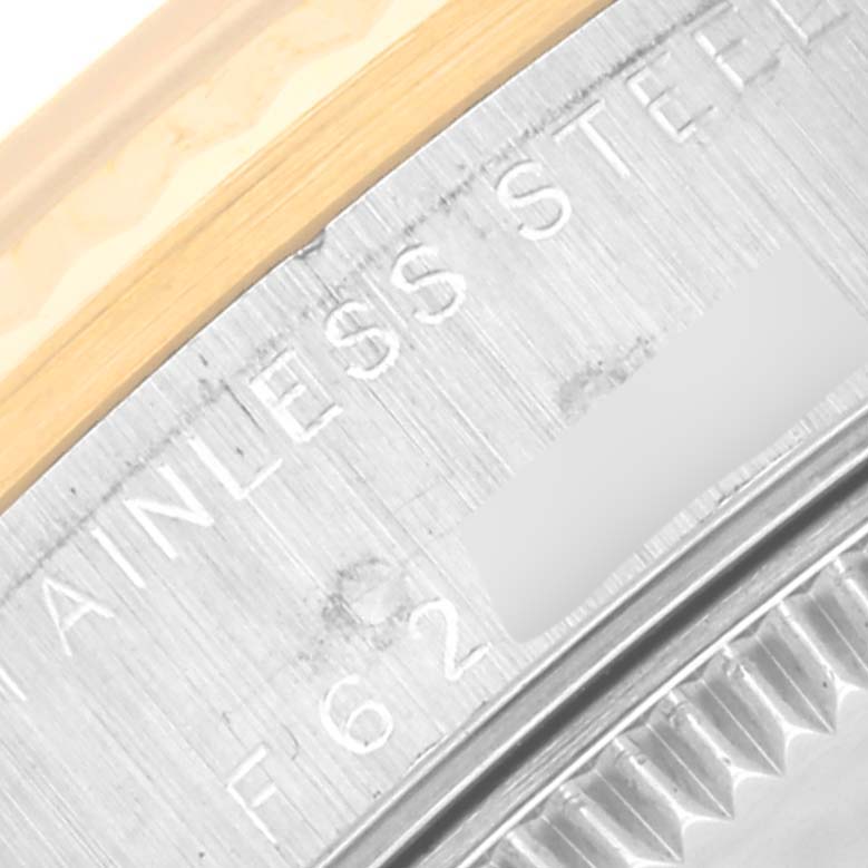 The image shows a close-up view of the caseback edge of a Mid-Size Rolex watch, highlighting the "STAINLESS STEEL" engraving.