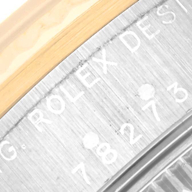 This close-up image shows the side engraving of the Mid-Size Rolex watch, highlighting the "ROLEX DESIGN" text and model number.