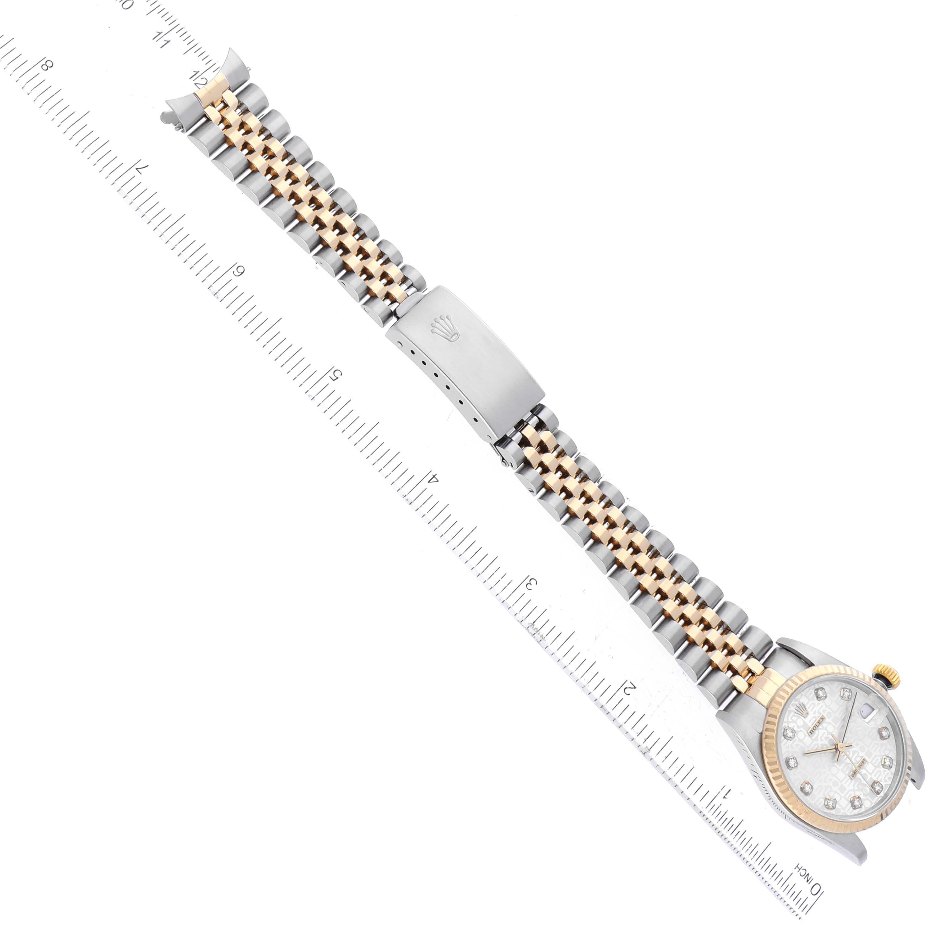 The image shows a top-down view of a Rolex Mid-Size 78273 Women's Steel and Gold (two tone) Silver Dial 78273 Women's Steel and Gold (two tone) Silver Dial model watch, highlighting its bracelet, clasp, and dial with rulers for scale.