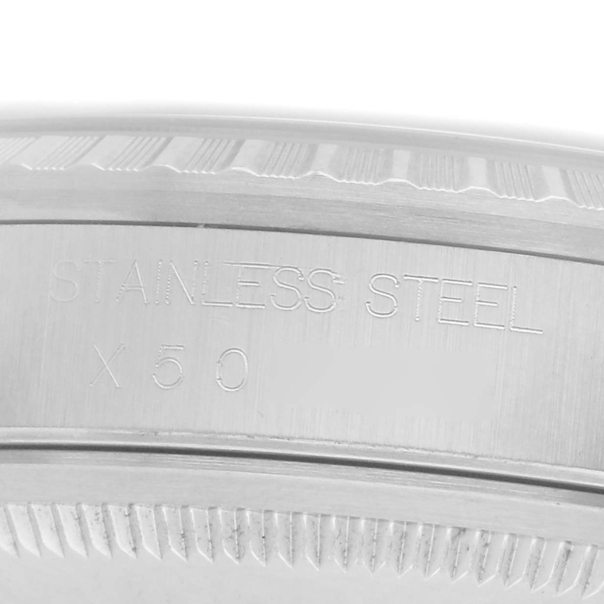The image shows a close-up of the Rolex Datejust model 16220 case side, highlighting the "STAINLESS STEEL" engraving.