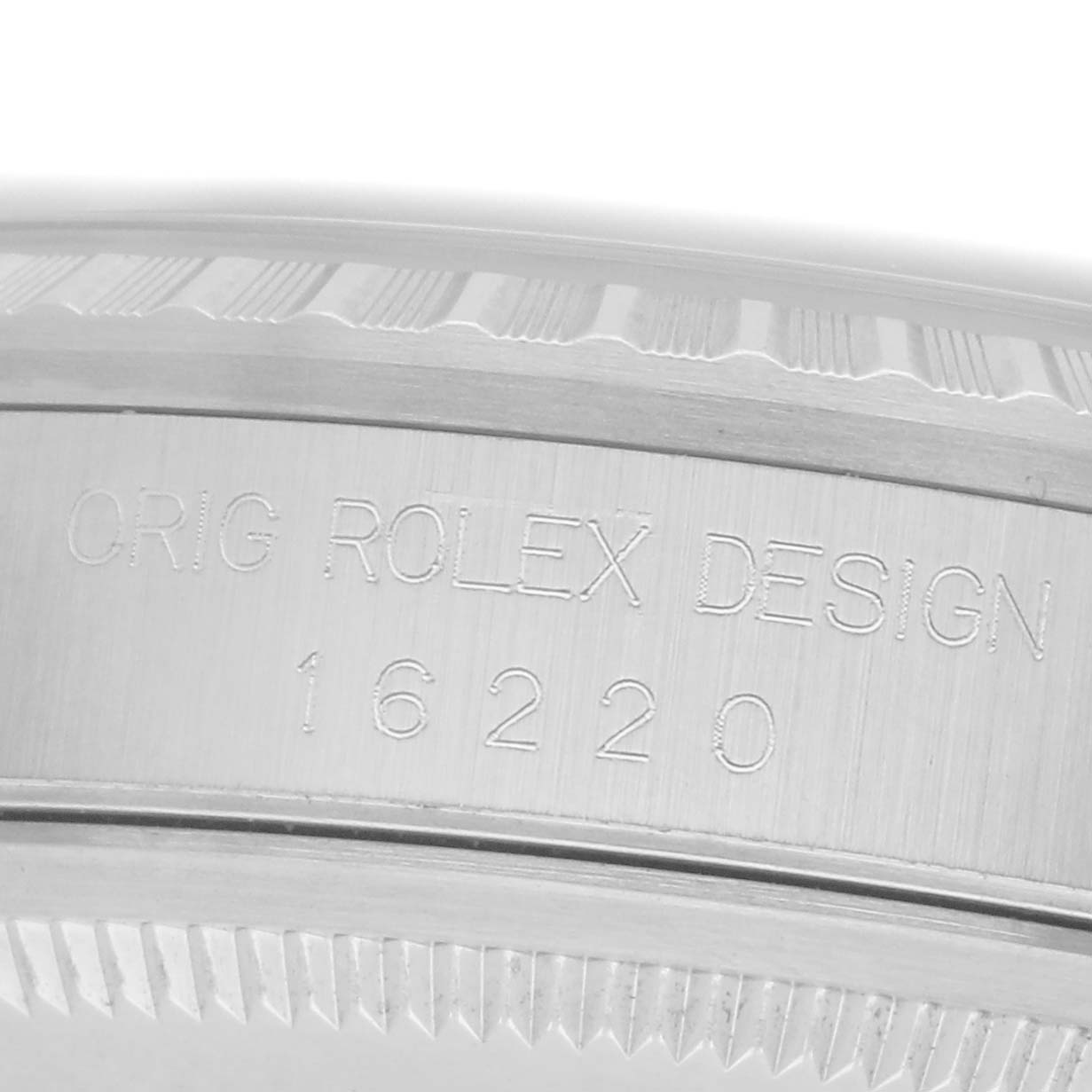 The image shows a close-up of the side of a Rolex Datejust, model 16220, focusing on the engraved model number and design details of the case.