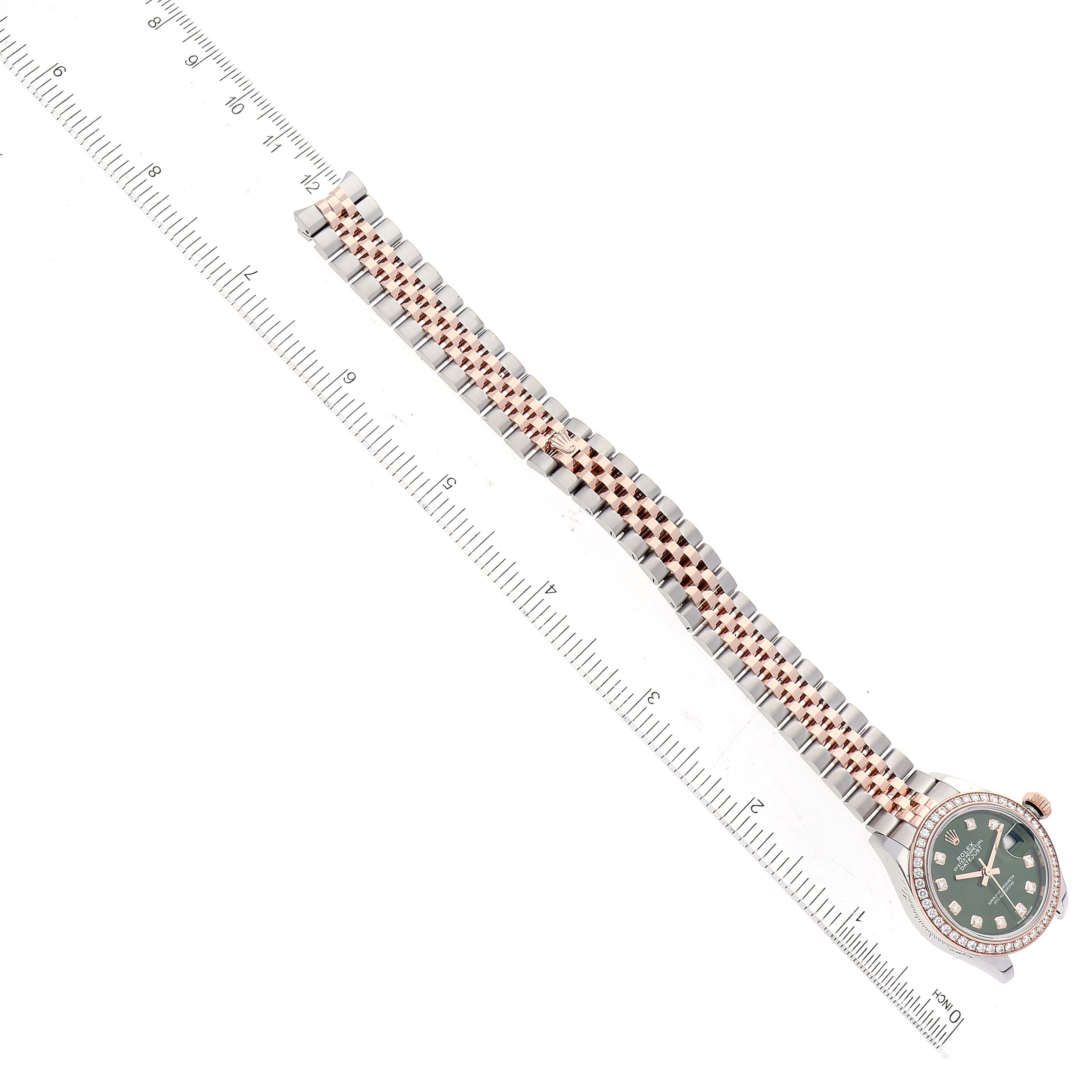 The image shows a top view of a Rolex Datejust 279381 Women's Steel and Gold (two tone) Green Dial 279381 Women's Steel and Gold (two tone) Green Dial watch, with its face, bezel, and full bracelet visible against a ruler for scale.