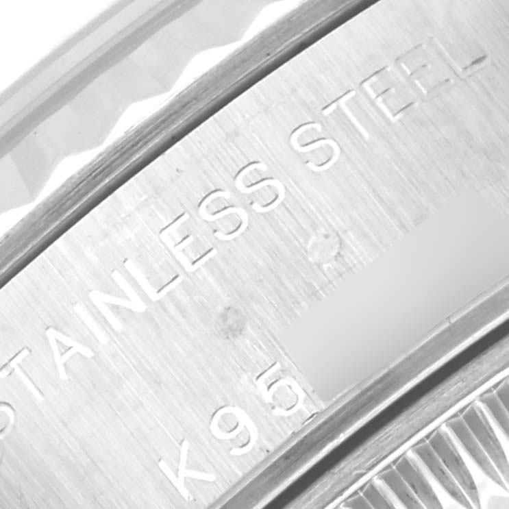 This close-up image of a Rolex Datejust 79174 Women's Stainless Steel Mother of Pearl Dial 79174 Women's Stainless Steel Mother of Pearl Dial watch shows the engraved text "STAINLESS STEEL" and part of the case edge.