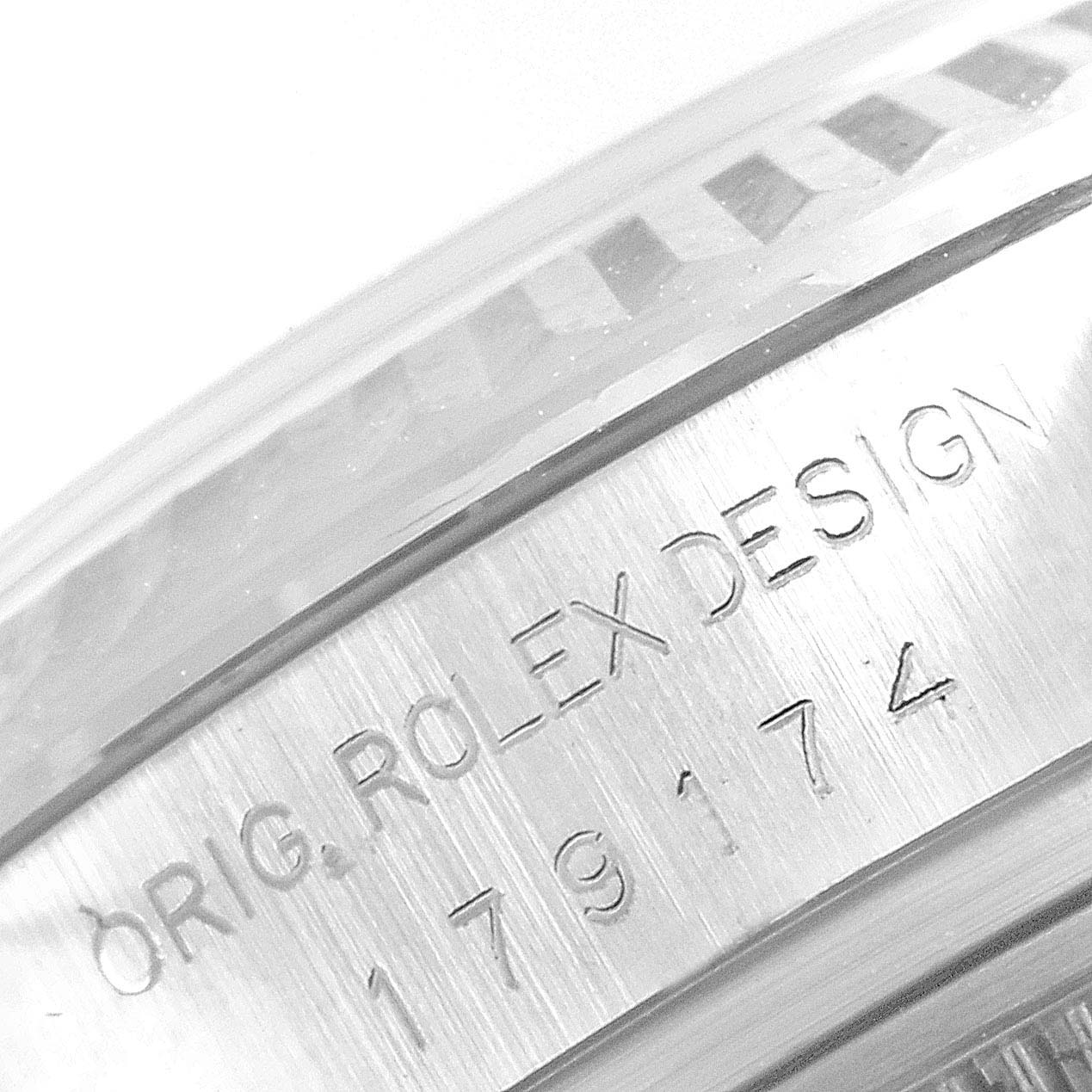 This image shows an angled close-up of the case side, showcasing the engraved serial number on a Rolex Datejust 179174 Women
s Stainless Steel Mother of Pearl Dial 179174 Women
s Stainless Steel Mother of Pearl Dial watch.