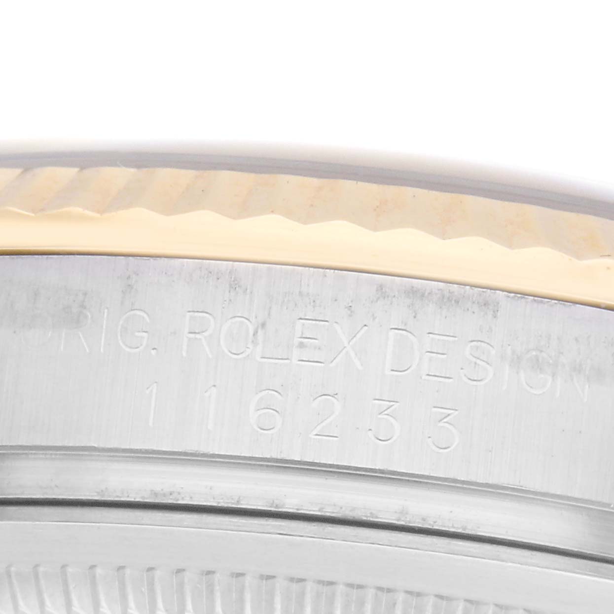 The image shows a close-up angle of the case side of the Rolex Datejust model 116233, highlighting the engraved model number on the watch
s metal surface.