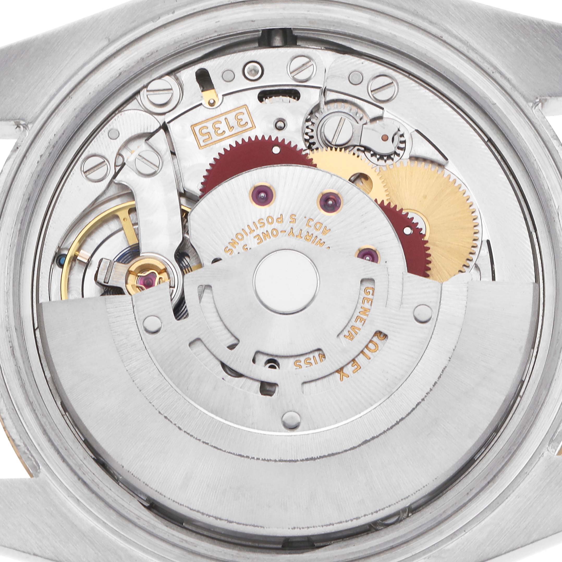 The image shows the Rolex Datejust model 116233 movement from the back, displaying its intricate mechanical components and rotor.
