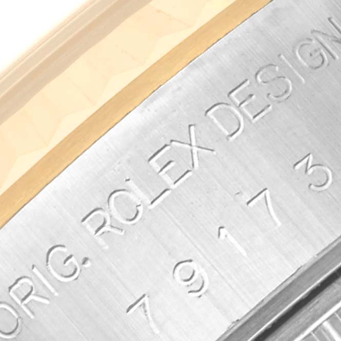 This close-up image shows part of the bezel and the engraved design markings of the Rolex Datejust 79173 Women's Steel and Gold (two tone) Blue Dial 79173 Women's Steel and Gold (two tone) Blue Dial watch.