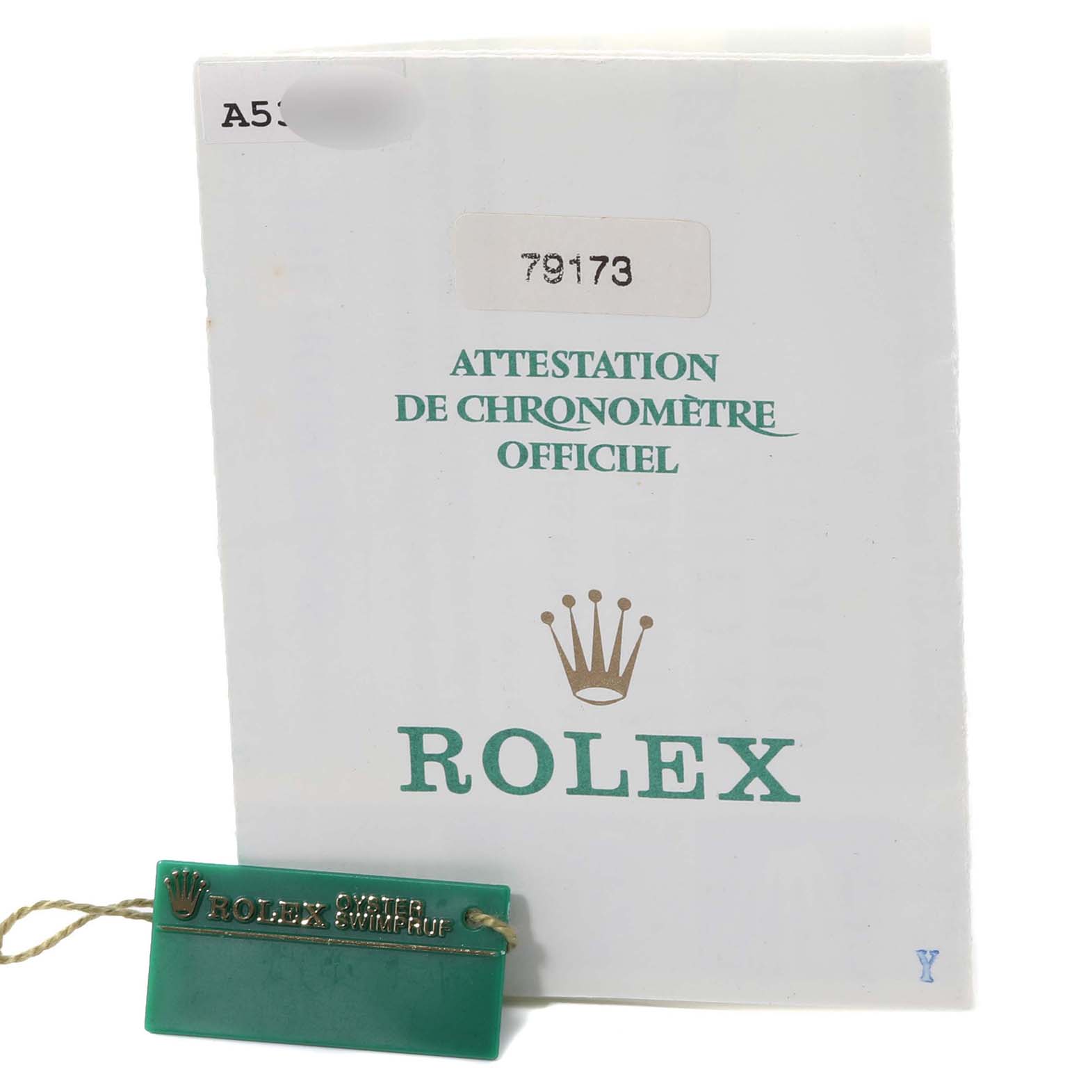 The image shows a Rolex Datejust 79173 Women's Steel and Gold (two tone) Blue Dial 79173 Women's Steel and Gold (two tone) Blue Dial warranty certificate and a green swing tag with the Rolex logo.