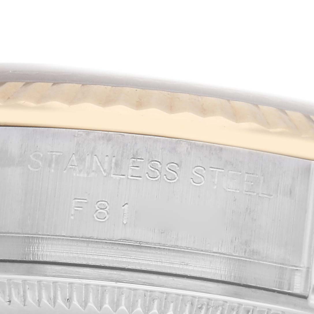 The image shows a close-up of the stainless steel side with engraving on a Rolex Datejust model 179173, highlighting the bezel
s edge.