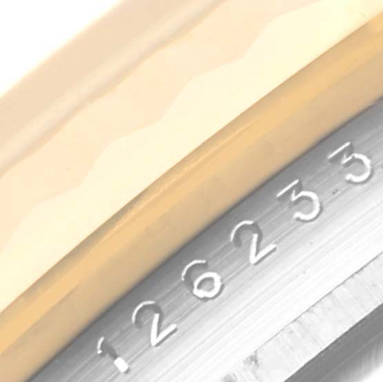 The image shows a close-up of the bezel and engraved numbers on the Datejust model by Rolex.