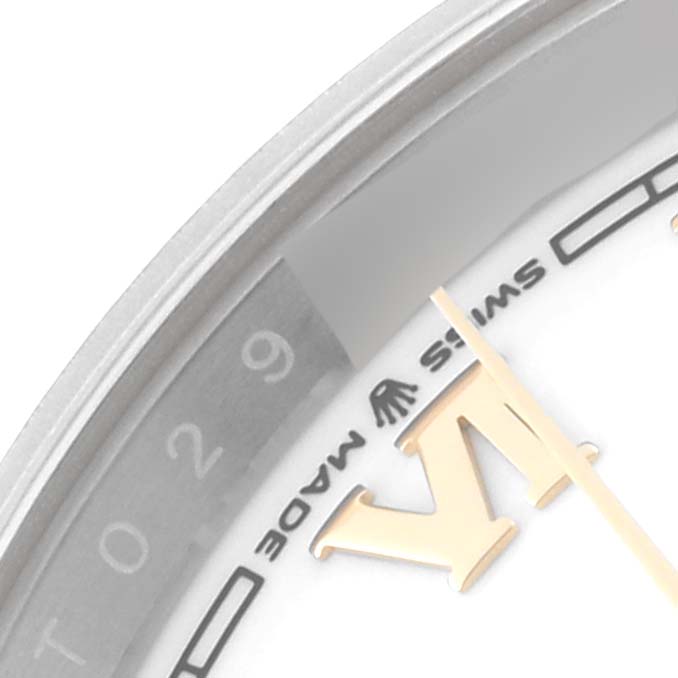 This close-up image of the Rolex Datejust 126233 Men's Steel and Gold (two tone) White Dial 126233 Men's Steel and Gold (two tone) White Dial watch shows the dial, part of the bezel, Roman numeral marker, and "Swiss Made" text.
