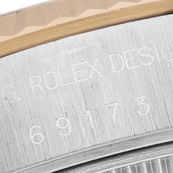 This close-up image shows the serial number engraving on the side of a Rolex Datejust 69173 Women's Steel and Gold (two tone) Blue Dial 69173 Women's Steel and Gold (two tone) Blue Dial watch.