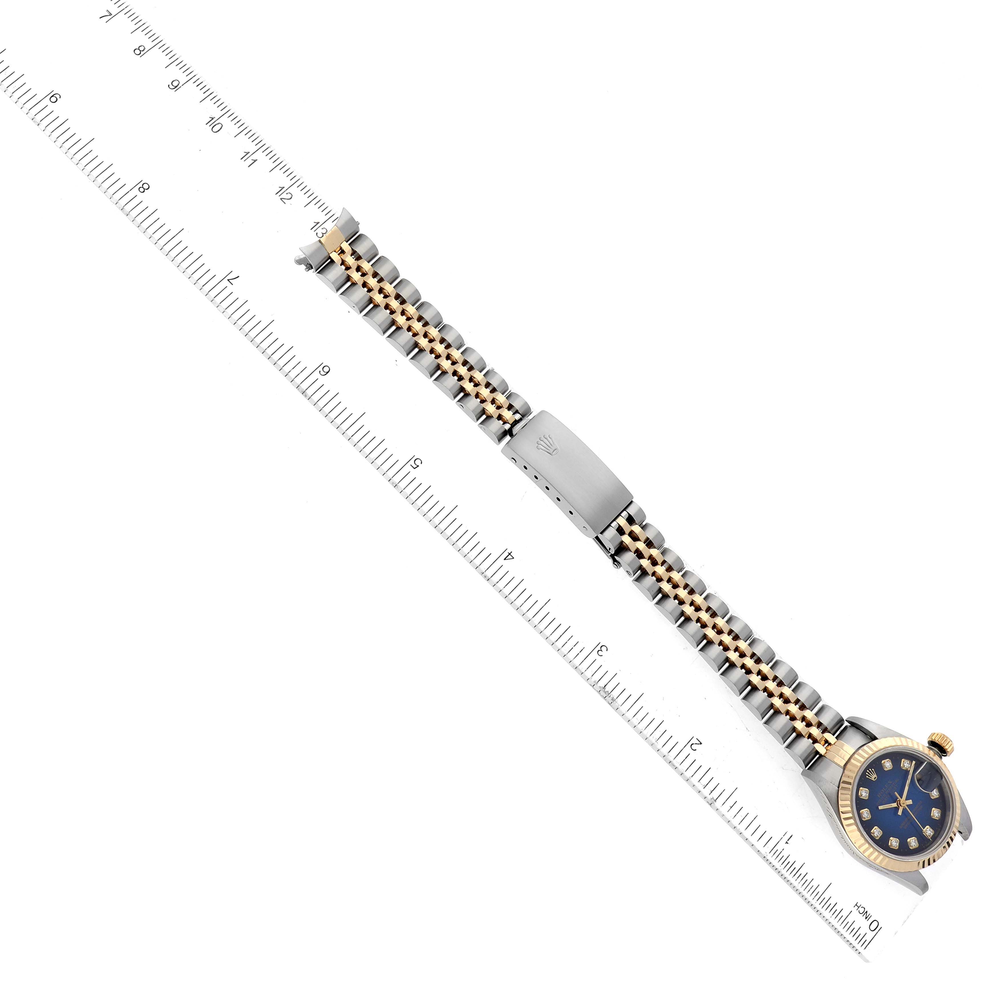 The image shows a Rolex Datejust 69173 Women's Steel and Gold (two tone) Blue Dial 69173 Women's Steel and Gold (two tone) Blue Dial watch from a top-down angle, displaying the watch face, bracelet, and clasp next to a ruler for scale.