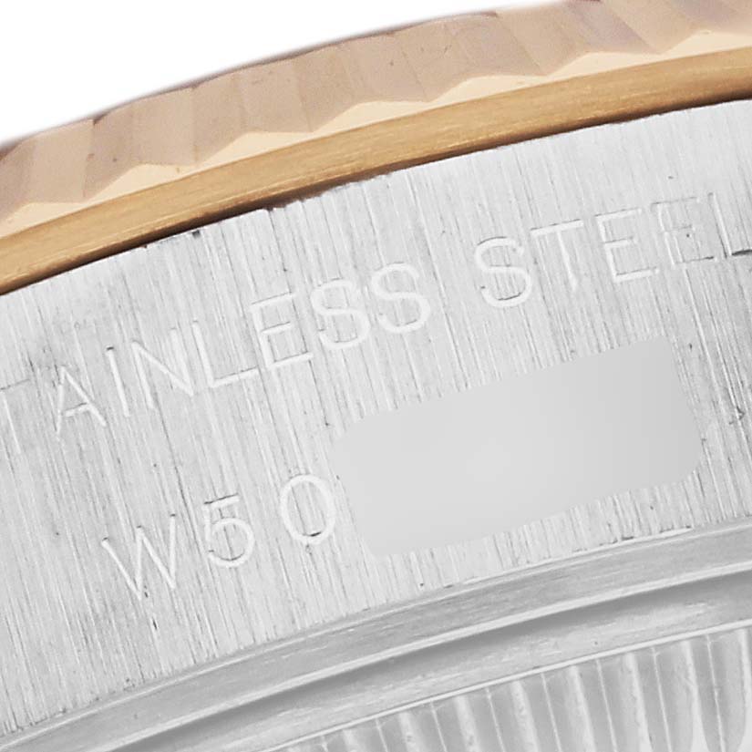 This close-up view of a Rolex Datejust 69173 Women's Steel and Gold (two tone) Blue Dial 69173 Women's Steel and Gold (two tone) Blue Dial watch displays the stainless steel case back and the gold fluted bezel.