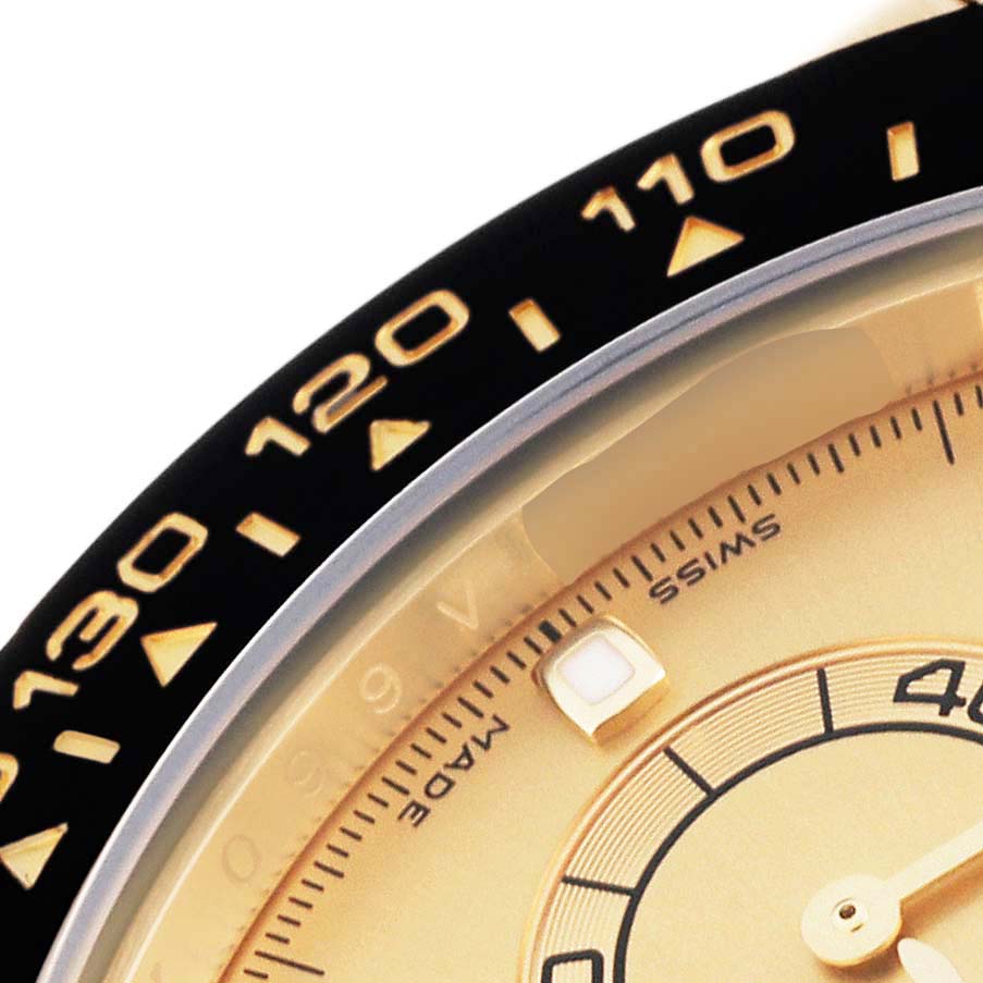 The image shows a close-up of the bezel, dial, and part of the face of a Rolex Daytona 116518 Men's Yellow Gold Champagne Dial 116518 Men's Yellow Gold Champagne Dial watch.