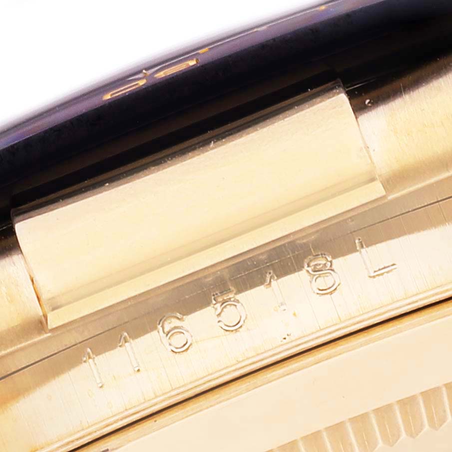 This image shows a close-up of the side of a Rolex Daytona 116518 Men's Yellow Gold Champagne Dial 116518 Men's Yellow Gold Champagne Dial watch, specifically the area near the serial number.