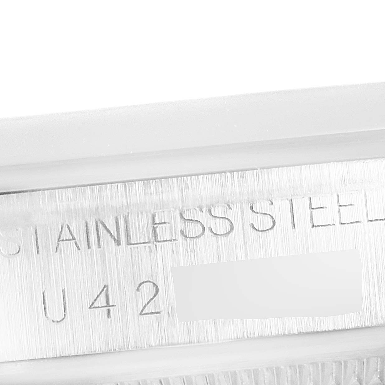 This close-up image shows the engraved stainless steel case side of a Rolex Explorer 14270 Men
s Stainless Steel Black Dial 14270 Men
s Stainless Steel Black Dial watch.