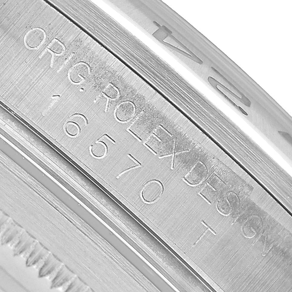 The image shows a close-up of the side engraving on the Rolex Explorer 16570 Men's Stainless Steel Black Dial, displaying "ORIG ROLEX DESIGN" and the model number 16570.