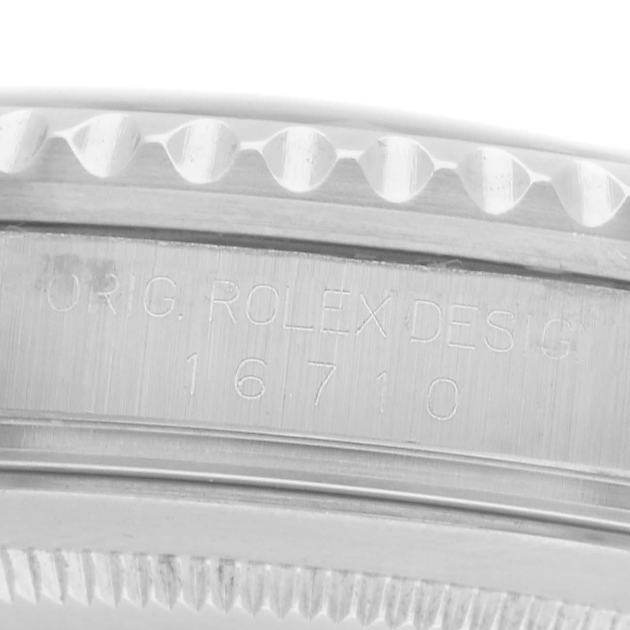 The image shows a close-up of the case side and bezel edge of the Rolex GMT-Master model 16710, revealing the model number engraving.