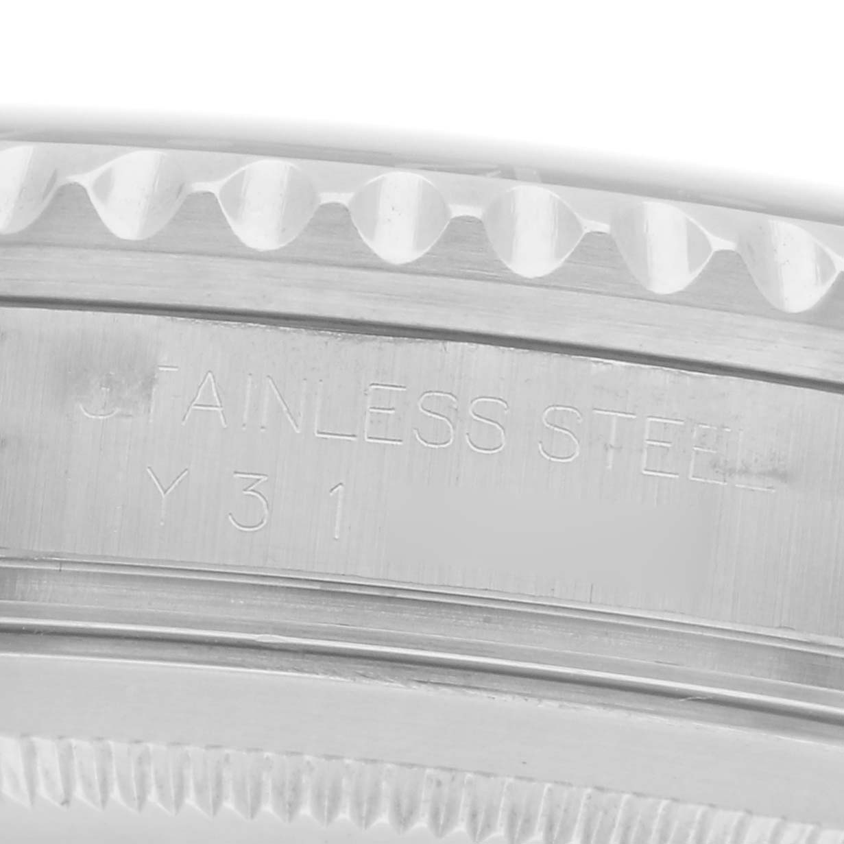 The image shows a close-up side view of the Rolex GMT-Master, model number 16710, focusing on the stainless steel part of the case with visible engravings.