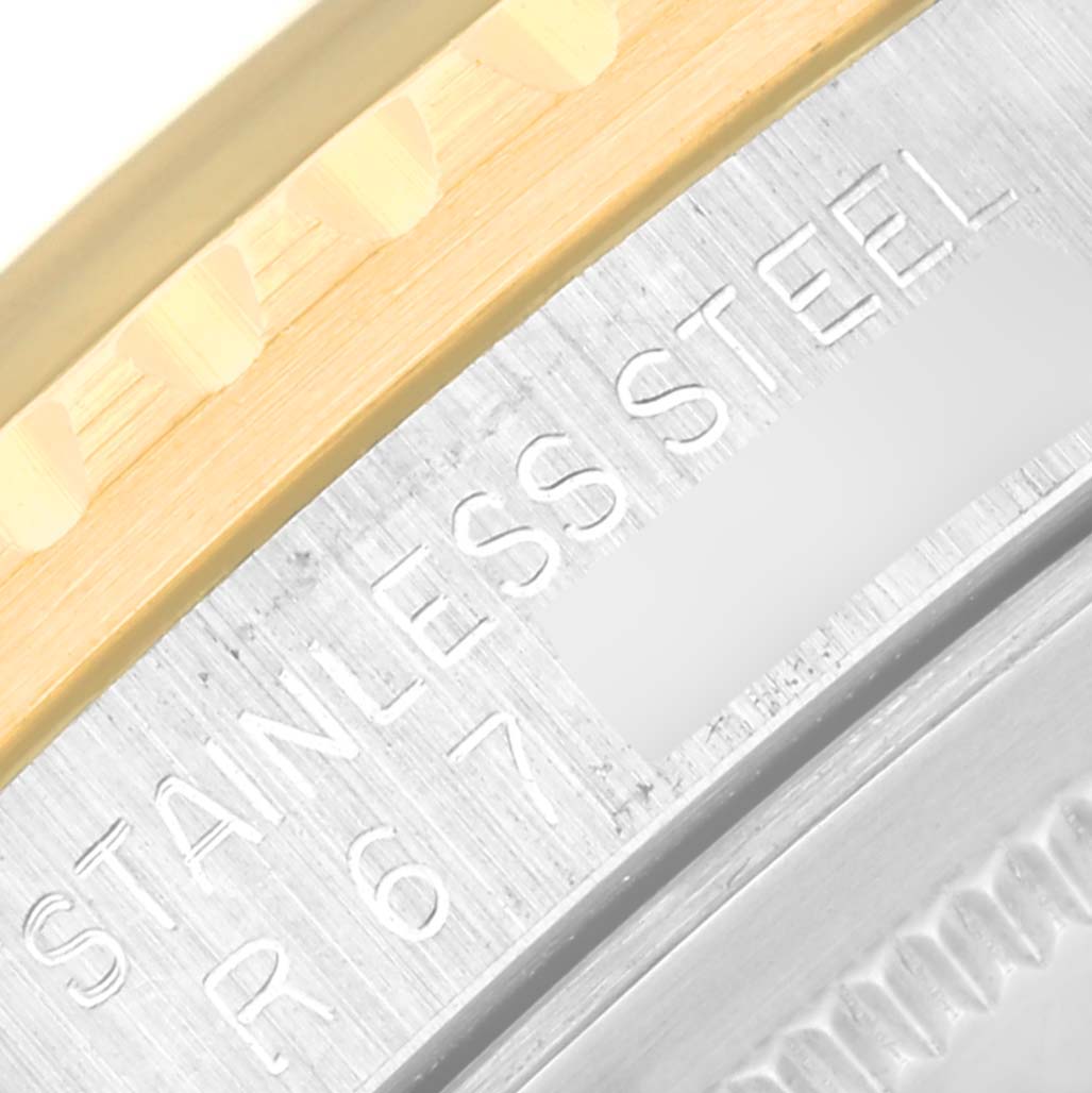 The image shows a close-up angle of the bezel and part of the case on a Rolex Vintage Collection 16753 Men's Steel and Gold (two tone) Black Dial 16753 Men's Steel and Gold (two tone) Black Dial watch, highlighting the "STAINLESS STEEL" engraving.