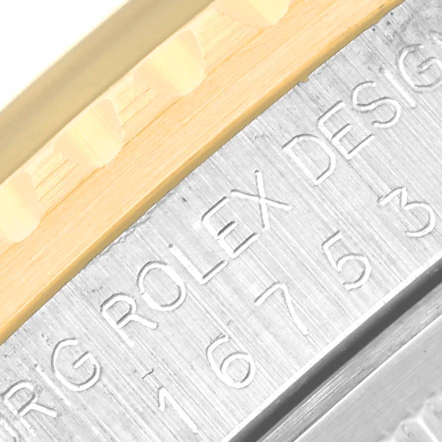 This image shows a close-up of the side view of a Vintage Collection Rolex watch bezel and engraved serial number.