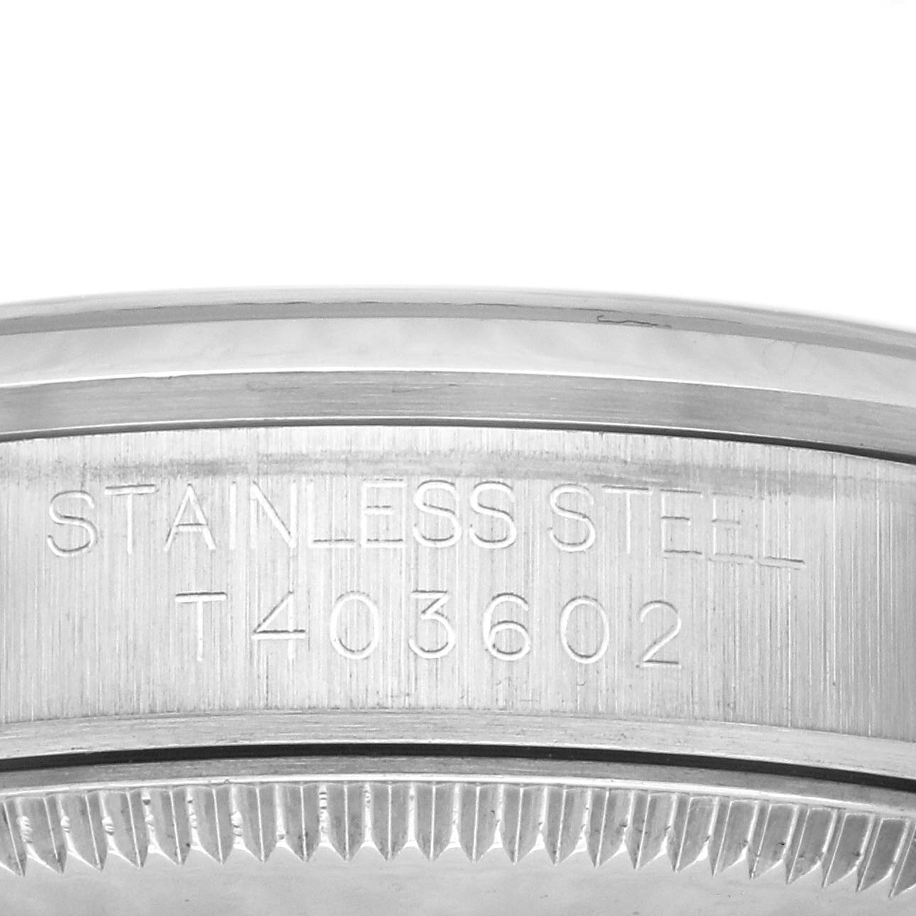 The image shows a close-up view of the case back edge and serial number engraving of a Rolex Mid-Size 67480 Women's Stainless Steel Blue Dial 67480 Women's Stainless Steel Blue Dial watch.