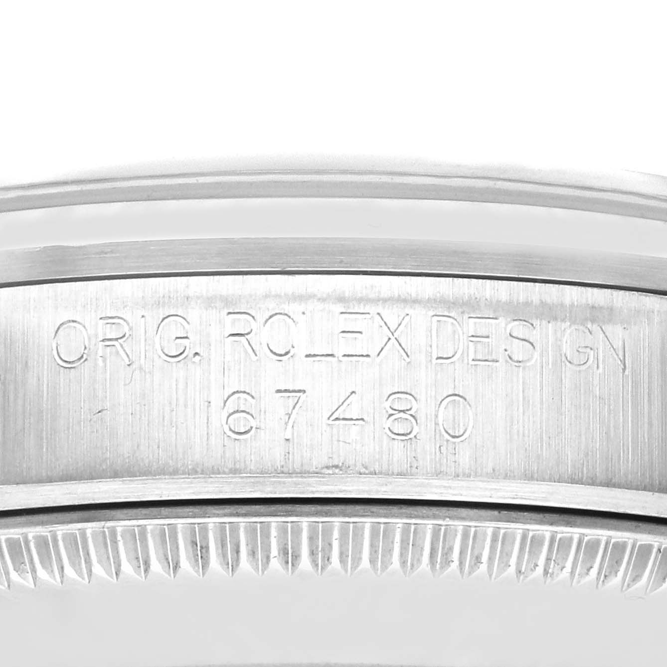 This image shows a close-up of the engraved case back of the Mid-Size Rolex watch, focusing on the model number 67480 and "ORIG. ROLEX DESIGN".