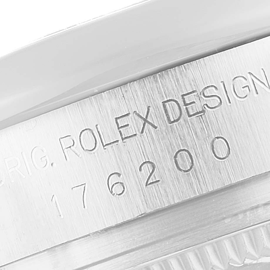 The image shows a close-up of the engraved side of the Rolex Oyster Perpetual 176200 Women's Stainless Steel Black Dial watch case.