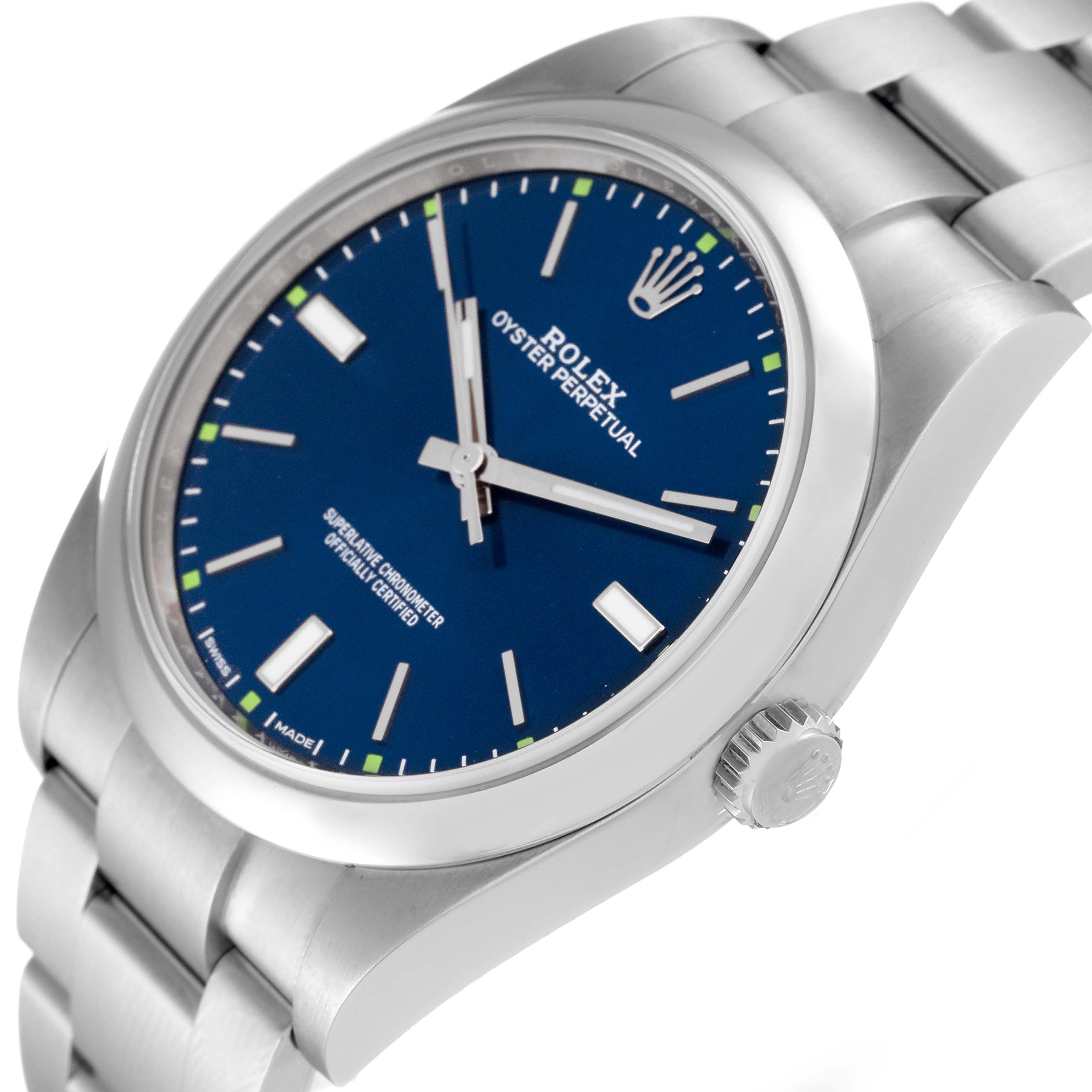 This image of a Rolex Oyster Perpetual 114300 Men
s Stainless Steel Blue Dial 114300 Men
s Stainless Steel Blue Dial watch shows the face, crown, and part of the bracelet at an angled view.