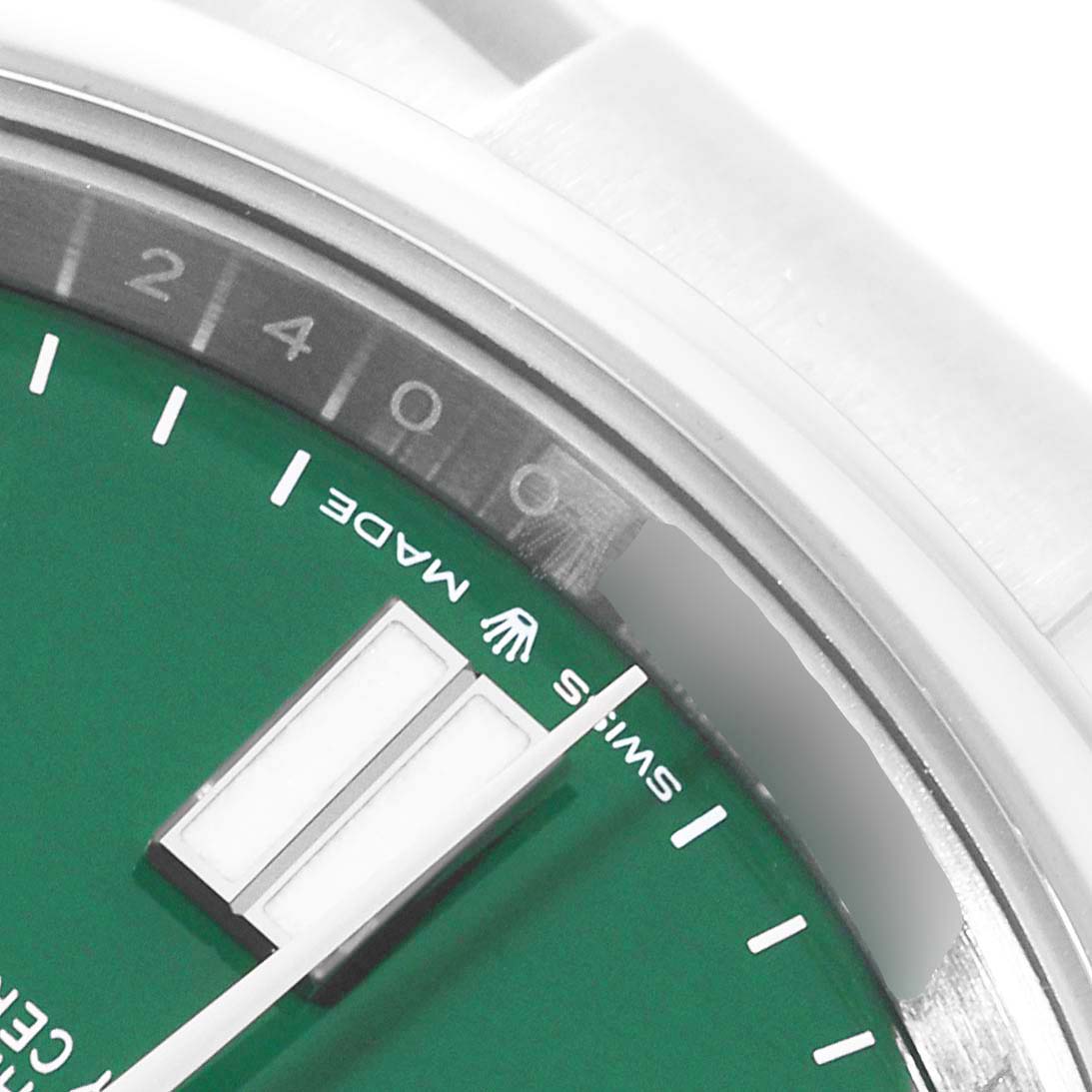 The image shows a close-up of the dial with the "Swiss Made" text and the edge of the bezel of the Rolex Oyster Perpetual 124300 Men's Stainless Steel Green Dial 124300 Men's Stainless Steel Green Dial watch.