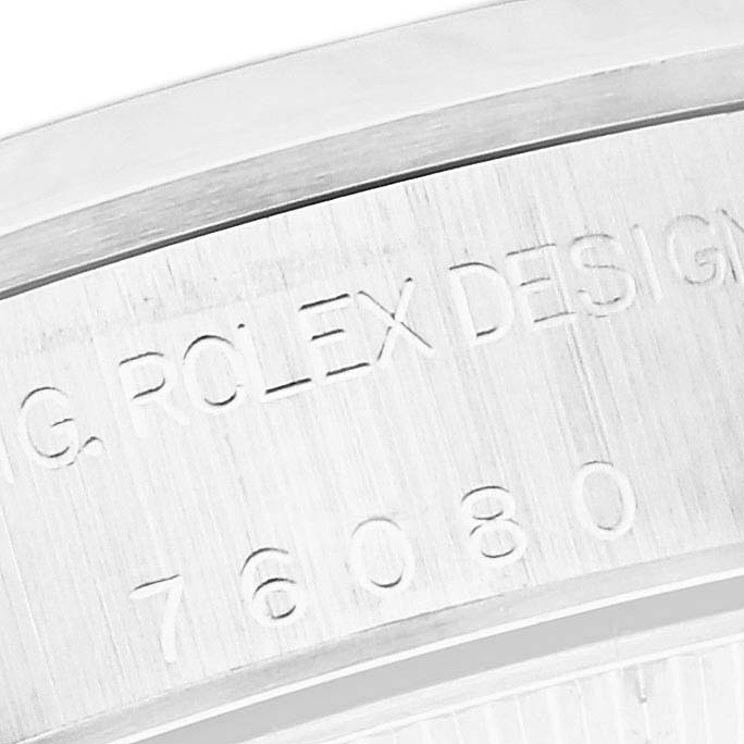 This image shows a close-up of the engraved text on the side of a Rolex Oyster Perpetual 76080 Women's Stainless Steel Pink Dial 76080 Women's Stainless Steel Pink Dial.