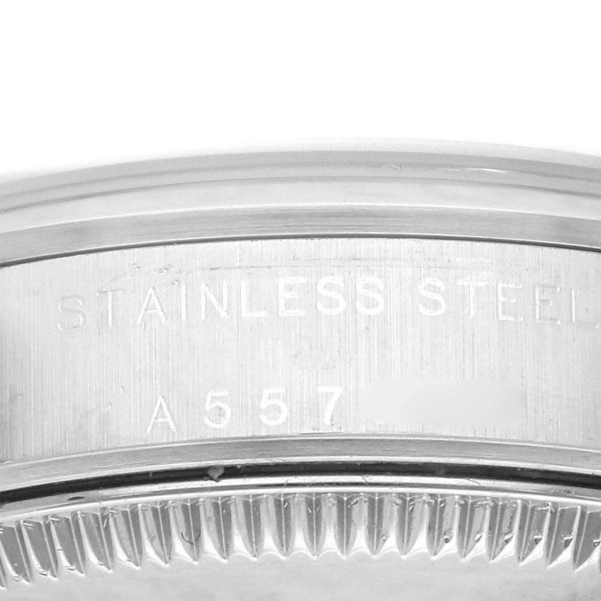 The image shows the engraved stainless steel case back of a Rolex Mid-Size 77080 Women's Stainless Steel Pink Dial 77080 Women's Stainless Steel Pink Dial model, including part of the reference number and serial number.